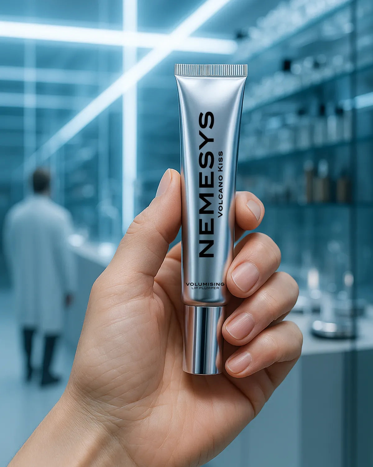 Tube de gloss NEMESYS Volcano Kiss tenu en main dans un laboratoire moderne, soin repulpant haut de gamme pour lèvres.
